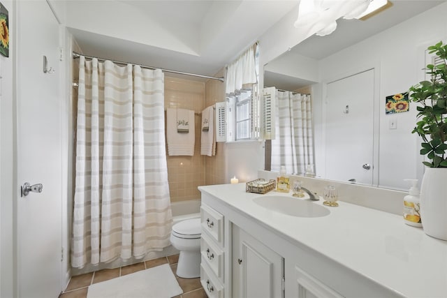 bathroom featuring vanity, tile patterned floors, toilet, and shower / bath combo with shower curtain