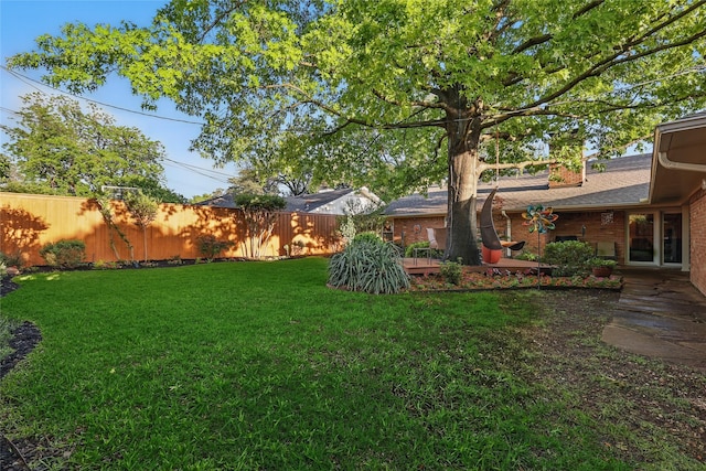 view of yard with fence and a wooden deck