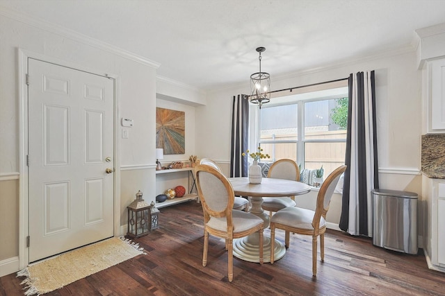 dining space featuring ornamental molding, an inviting chandelier, baseboards, and dark wood-type flooring