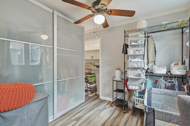 bathroom featuring ornamental molding, ceiling fan, wood finished floors, and baseboards