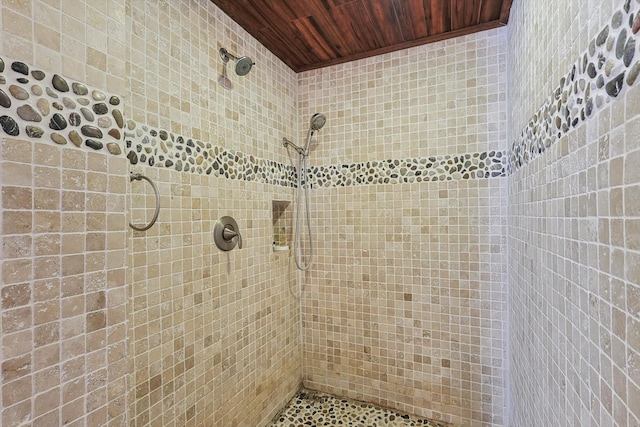 full bath featuring wood ceiling and a tile shower