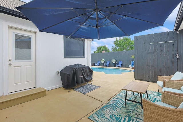 view of swimming pool with a fenced in pool, a patio area, grilling area, and fence