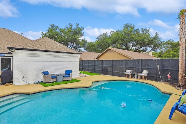 view of swimming pool with a patio, a fenced in pool, and a fenced backyard