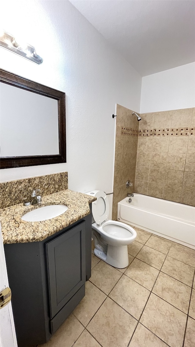 full bathroom featuring tile patterned floors, toilet, washtub / shower combination, and vanity