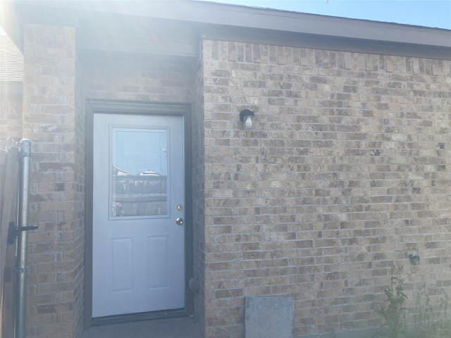 entrance to property with brick siding