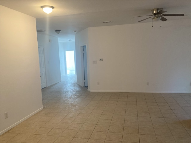 unfurnished room featuring ceiling fan, visible vents, and baseboards