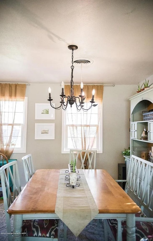 509 W 3rd St, Claude, TX 79019 - dining area with visible vents and a notable chandelier
