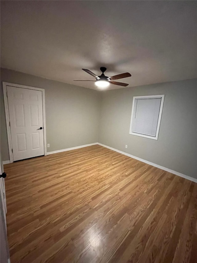 509 W 3rd St, Claude, TX 79019 - unfurnished room with baseboards, wood finished floors, and a ceiling fan