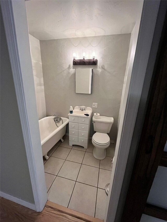 509 W 3rd St, Claude, TX 79019 - full bath with toilet, tile patterned flooring, a freestanding bath, and vanity