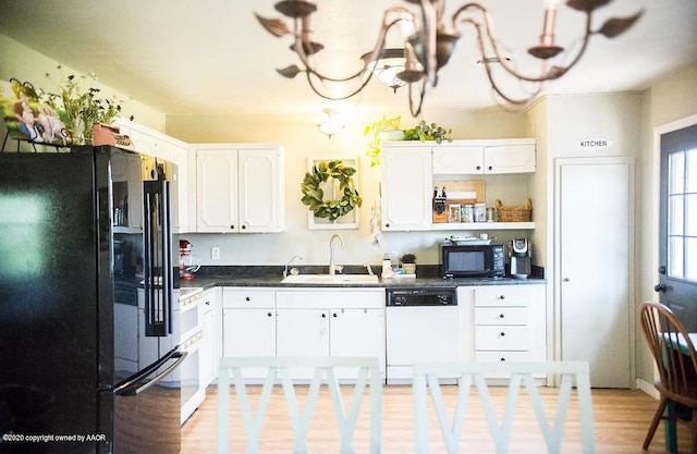 509 W 3rd St, Claude, TX 79019 - kitchen with a sink, open shelves, black appliances, white cabinetry, and dark countertops