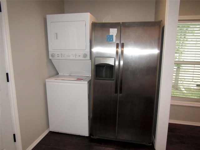 316 Tennessee St, Graham, TX 76450 - washroom with stacked washer / drying machine, laundry area, plenty of natural light, and baseboards