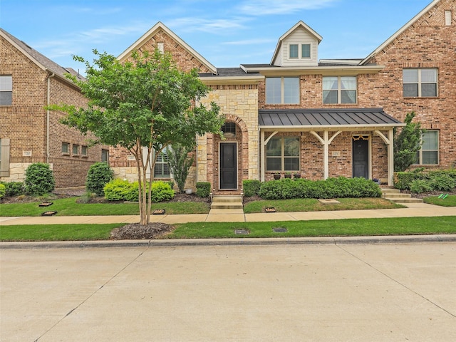 1267 Casselberry Dr, Flower Mound, TX 75028 - view of property with a standing seam roof and brick siding