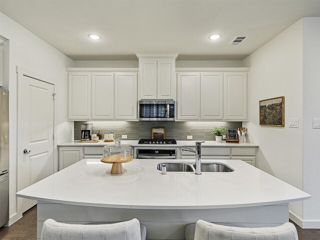 1267 Casselberry Dr, Flower Mound, TX 75028 - kitchen with a sink, stainless steel microwave, wall oven, backsplash, and visible vents