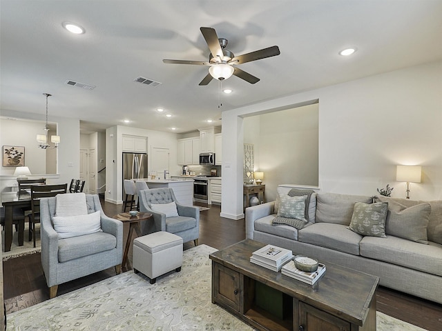 1267 Casselberry Dr, Flower Mound, TX 75028 - living area with recessed lighting, wood finished floors, visible vents, and ceiling fan with notable chandelier