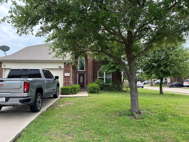 view of property hidden behind natural elements with a garage, a front lawn, roof with shingles, brick siding, and driveway