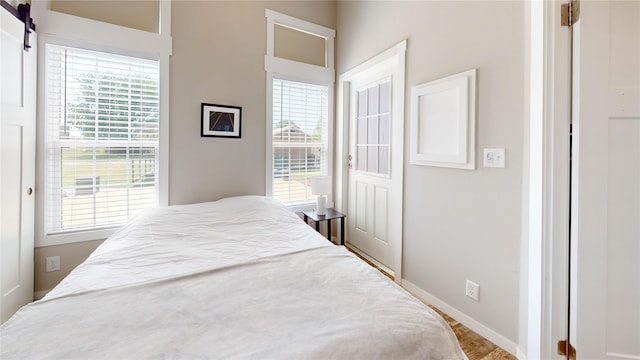 bedroom featuring baseboards and multiple windows