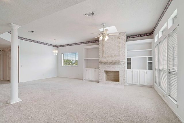 unfurnished living room featuring a textured ceiling, carpet flooring, visible vents, a fireplace, and a ceiling fan