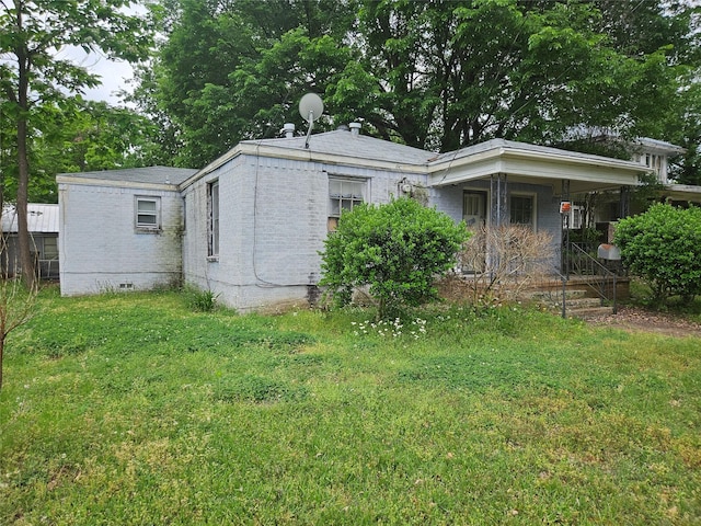 715 W Kaufman St, Paris, TX 75460 - view of home's exterior featuring a lawn, crawl space, and brick siding