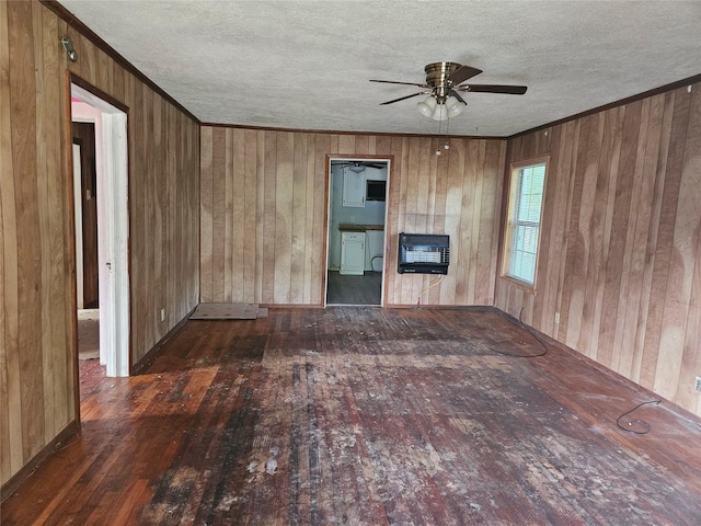715 W Kaufman St, Paris, TX 75460 - unfurnished living room featuring wooden walls, hardwood / wood-style flooring, ceiling fan, and a textured ceiling