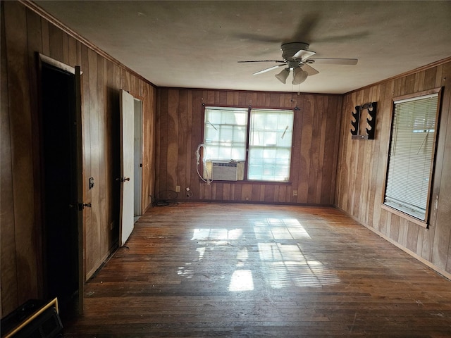 715 W Kaufman St, Paris, TX 75460 - spare room with wooden walls, cooling unit, ceiling fan, and hardwood / wood-style flooring
