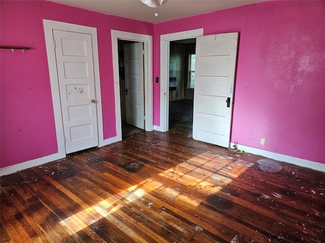 715 W Kaufman St, Paris, TX 75460 - unfurnished bedroom with baseboards and wood-type flooring