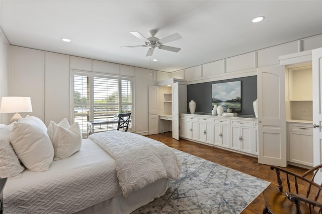 bedroom with recessed lighting, ceiling fan, and a decorative wall