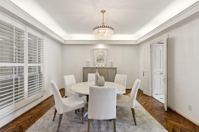 dining area with a chandelier and baseboards