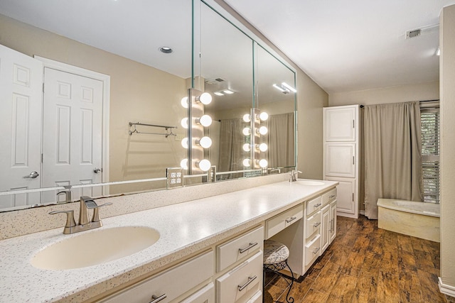 7324 Old Mill Run, Fort Worth, TX 76133 - bathroom with visible vents, double vanity, a sink, and wood finished floors