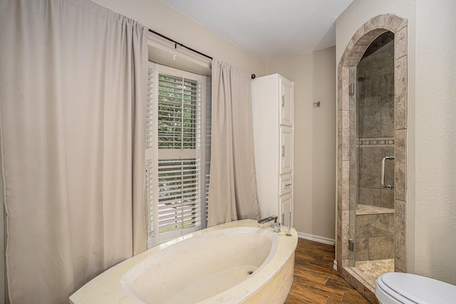 7324 Old Mill Run, Fort Worth, TX 76133 - full bathroom featuring toilet, wood finished floors, a stall shower, baseboards, and a bath