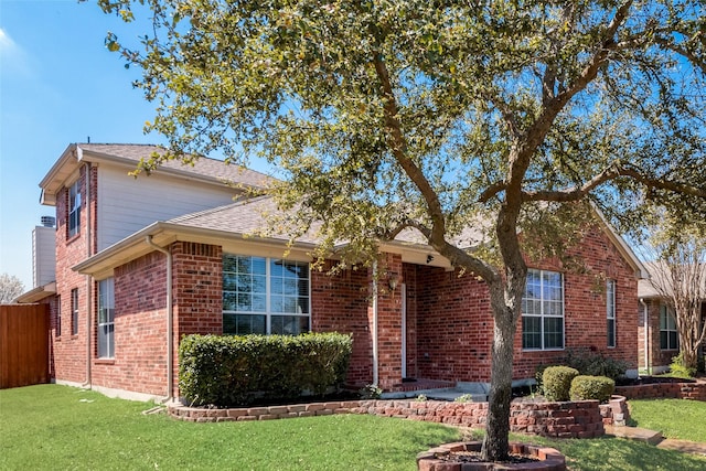 2925 Clear Creek Dr, Rockwall, TX 75032 - traditional-style home featuring fence, a front yard, and brick siding