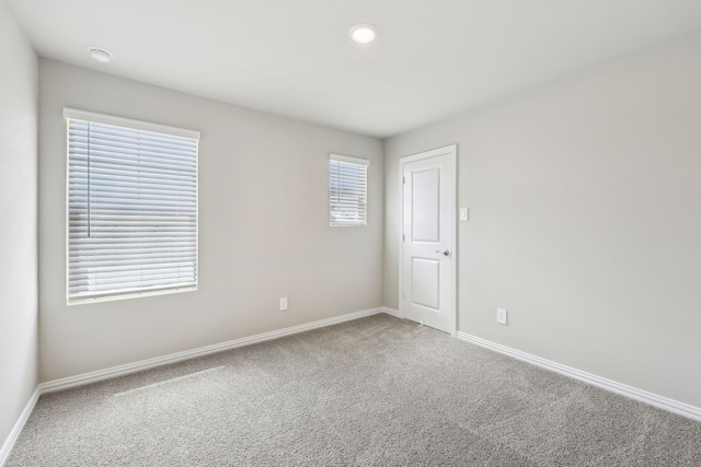 carpeted spare room with recessed lighting and baseboards