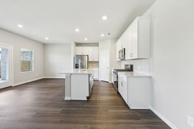 kitchen with recessed lighting, appliances with stainless steel finishes, light countertops, backsplash, and white cabinetry