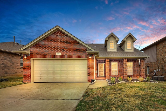 view of front of property with a front yard, a shingled roof, brick siding, concrete driveway, and an attached garage