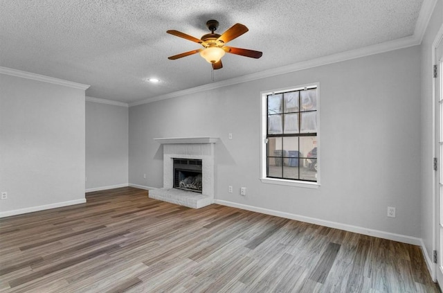5316 Columbia Ave, Dallas, TX 75214 - unfurnished living room featuring a brick fireplace, a ceiling fan, baseboards, a textured ceiling, and wood finished floors