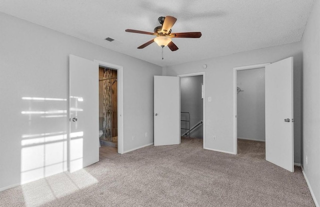 5316 Columbia Ave, Dallas, TX 75214 - unfurnished bedroom with connected bathroom, a closet, carpet flooring, a walk in closet, and visible vents