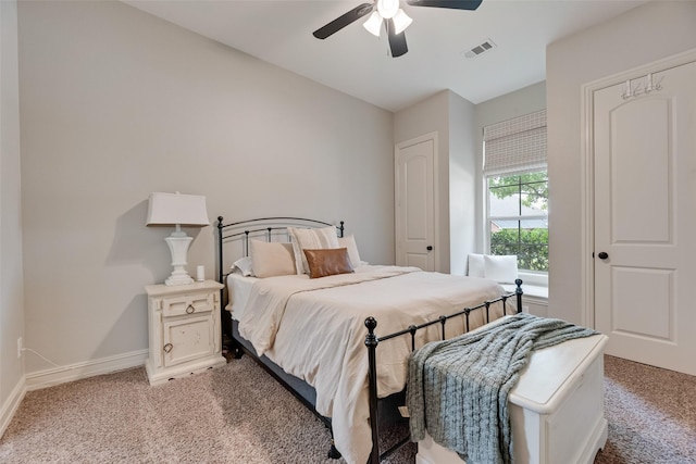 bedroom featuring baseboards, ceiling fan, visible vents, and light carpet