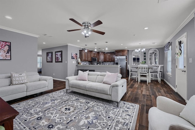 717 S Elm St, Sherman, TX 75090 - living room featuring dark wood-style flooring, recessed lighting, ornamental molding, and ceiling fan with notable chandelier