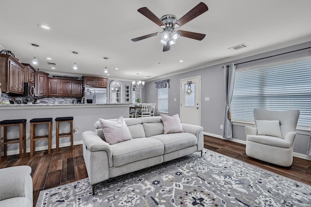 717 S Elm St, Sherman, TX 75090 - living room featuring dark wood-style floors, recessed lighting, visible vents, and ceiling fan with notable chandelier