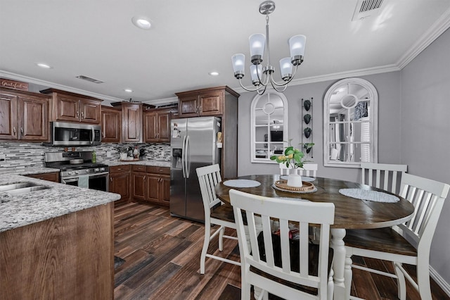 717 S Elm St, Sherman, TX 75090 - kitchen with tasteful backsplash, visible vents, ornamental molding, appliances with stainless steel finishes, and dark wood finished floors