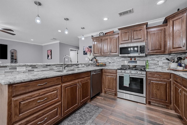717 S Elm St, Sherman, TX 75090 - kitchen with stainless steel appliances, ornamental molding, dark wood-style flooring, a sink, and visible vents