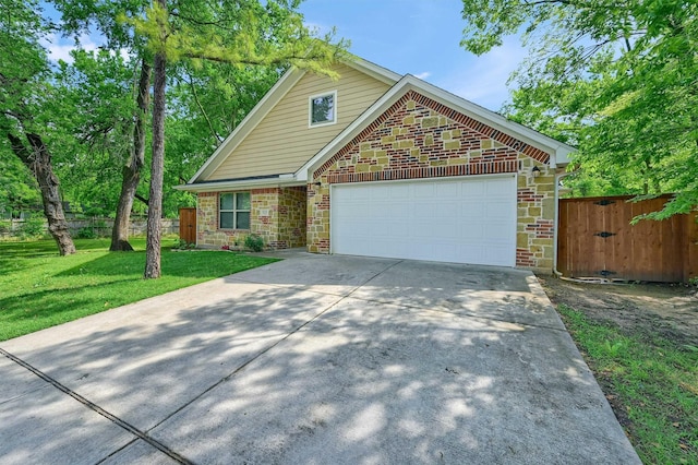 717 S Elm St, Sherman, TX 75090 - view of front of property featuring a front lawn, a garage, brick siding, concrete driveway, and fence