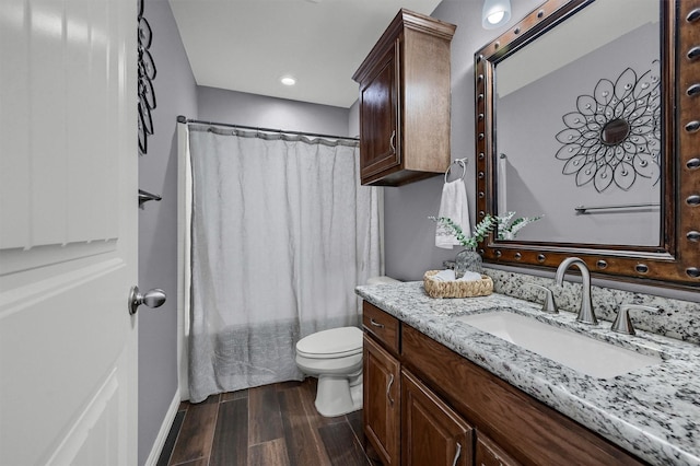 717 S Elm St, Sherman, TX 75090 - full bathroom with wood finished floors, toilet, a shower with shower curtain, and vanity