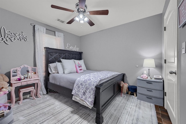 717 S Elm St, Sherman, TX 75090 - bedroom featuring visible vents, wood finished floors, and a ceiling fan