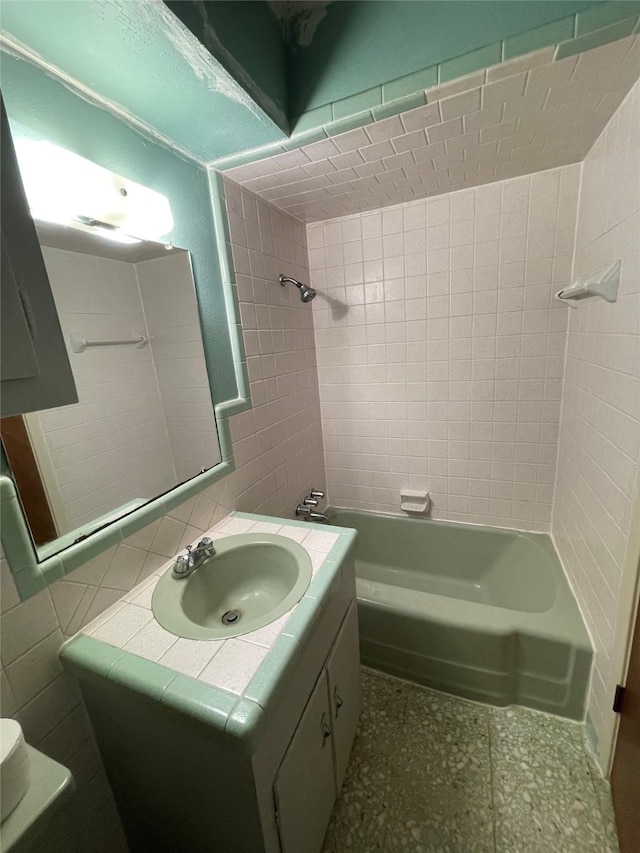 full bath featuring toilet, tile walls, shower / bathtub combination, and vanity
