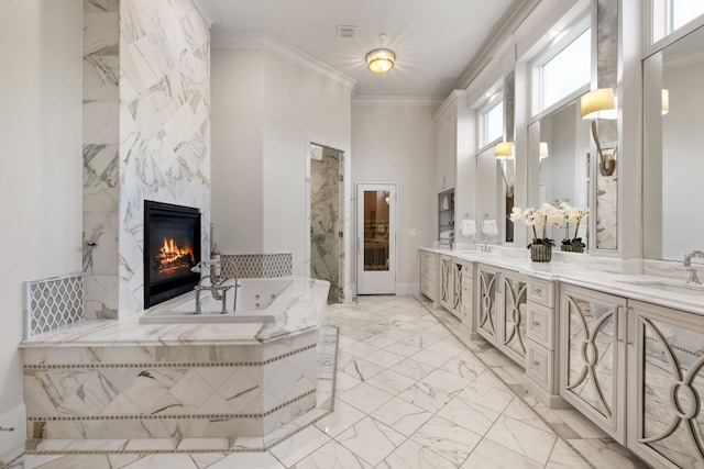 bathroom featuring a sink, a tub with jets, marble finish floor, ornamental molding, and a high end fireplace