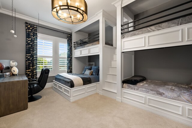 carpeted bedroom with ornamental molding and a notable chandelier