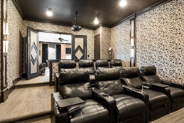 cinema featuring wallpapered walls, ornamental molding, ceiling fan, and carpet floors