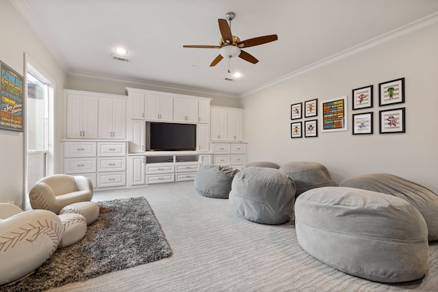 carpeted living area with visible vents, ornamental molding, ceiling fan, and recessed lighting