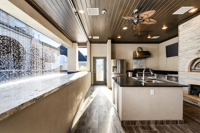 kitchen featuring visible vents, ceiling fan, wood ceiling, and a sink