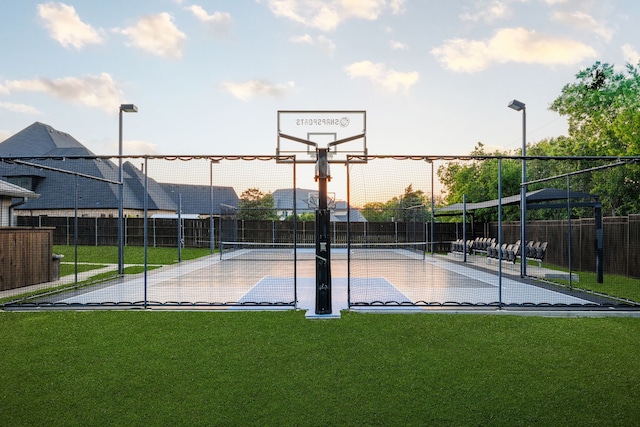 view of sport court with a tennis court, fence, community basketball court, and a yard